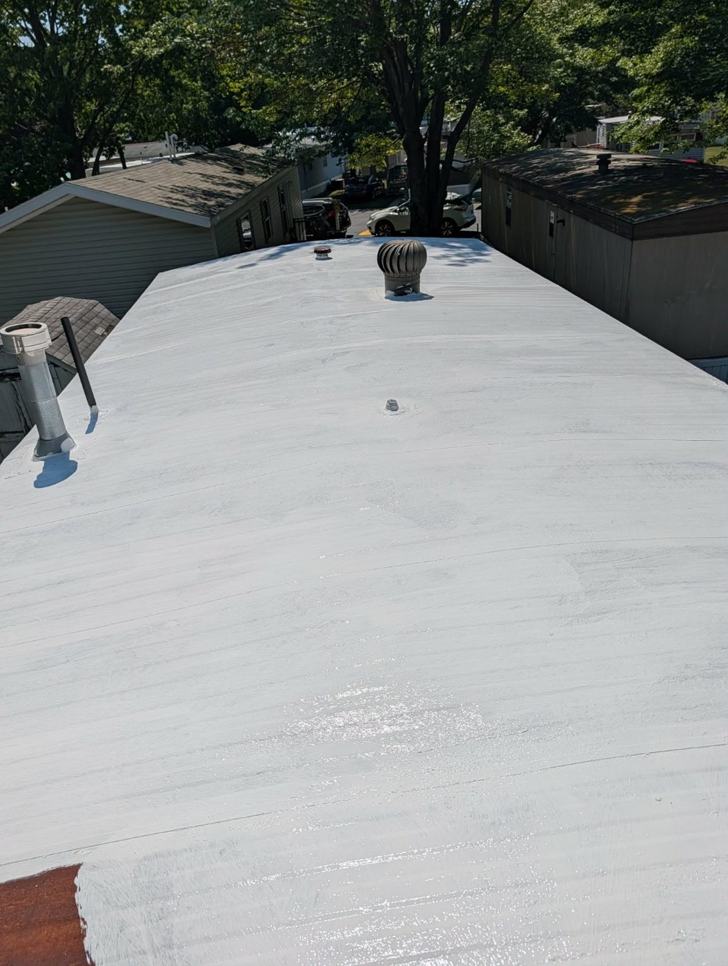 Same roof after white reflective coating