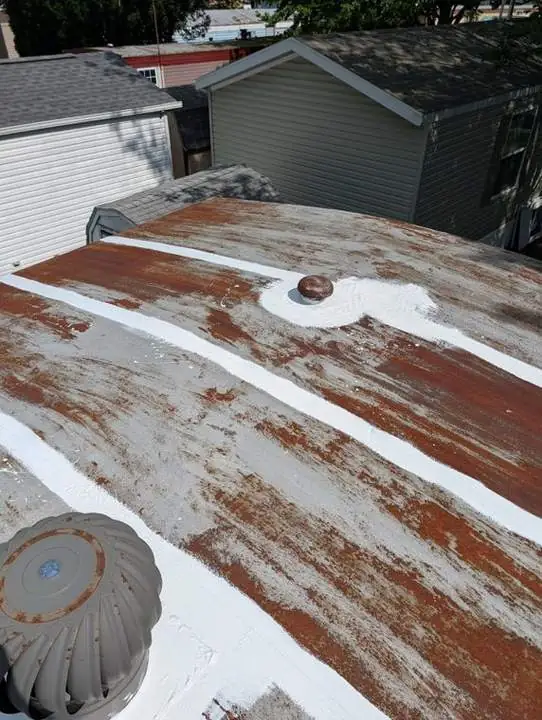 Prepared manufactured home roof during rust treatment and priming